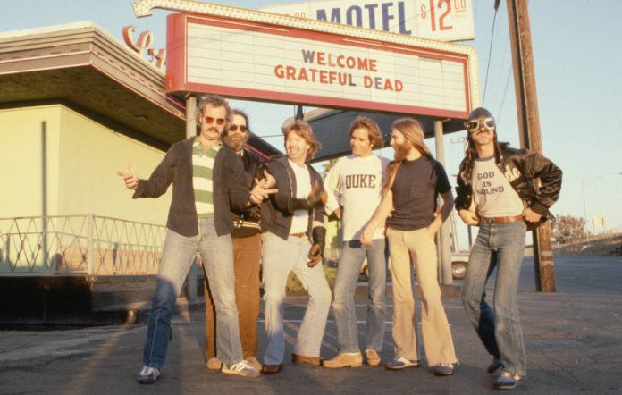 Members of the rock group Grateful Dead are Bill Kreutzman (striped shirt), Jerry Garcia (black shirt and jacket), Mickey Hart (